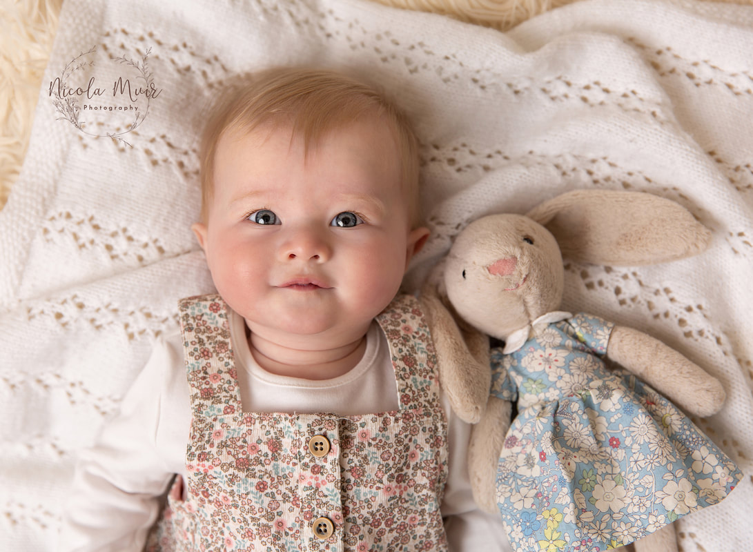nicola muir photography portrait session baby girl 5 months old smiling with bunny 